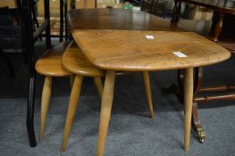 An Ercol light elm coffee table and two similar tables.
