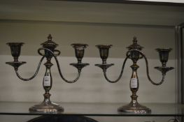 A pair of plated two branch three light candelabra.