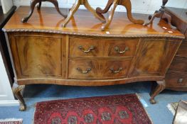 A Georgian style mahogany serpentine fronted sideboard on carved cabriole legs with claw and ball