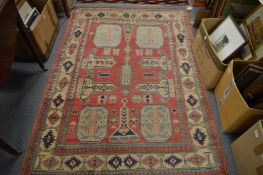 A Persian rug, pink ground with stylised decoration 175cm x 125cm.