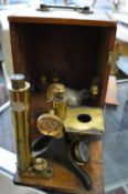 A mahogany cased brass microscope.