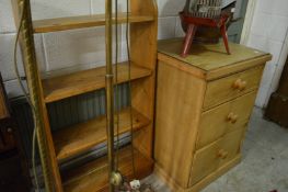 A pine bookshelf and a pine three drawer chest.