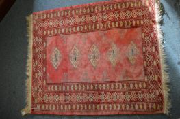 A small Tekke rug, pink ground with five central medallions 102cm x 86cm.