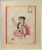 KALIGHAT SCHOOL BENGAL PAINTING ON PAPER OF A LADY WITH BIRD, with mount and mount board surround;