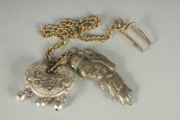 A CHINESE JADE INSET WHITE PENDANT, together with another white metal pendant (2).