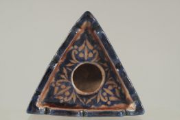 AN ISLAMIC GLAZED POTTERY INKWELL.