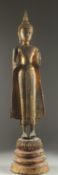A FINE AND LARGE 19TH CENTURY OR EARLIER THAI GILDED BRONZE BUDDHA, stood upon a graduating circular