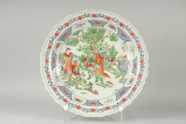 A LARGE CHINESE FAMILLE VERTE PORCELAIN CHARGER, painted with figures around a tree, 45cdm