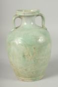 A CHINESE CELADON GLAZE TWIN HANDLE POTTERY VASE, (af), 23cm high.