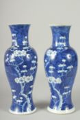 A PAIR OF CHINESE BLUE AND WHITE PORCELAIN PRUNUS BALUSTER VASES, 30cm high.