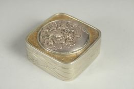 A SMALL SIGNED JAPANESE WHITE METAL AND BRASS BOX, the hinged lid with relief dragon roundel, 5cm