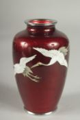 A JAPANESE GINABARI CLOISONNE VASE, decorated with cranes in flight, 12cm high.