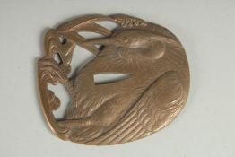 A JAPANESE ENGRAVED BRASS OPENWORKED TSUBA, designed with an egret, 9.5cm x 8cm.