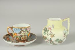 A JAPANESE PORCELAIN CUP AND SAUCER, together with a porcelain jug, (3).