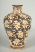 A CHINESE JIZHOU KILN POTTERY VASE, with lilipad and flower head decoration, 19cm high.