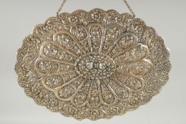 A 19TH CENTURY OTTOMAN EMBOSSED SILVER MIRROR, with relief floral decoration and hanging chain, 30.