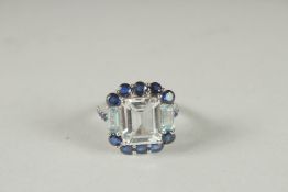 A LARGE SILVER WHITE TOPAZ, SAPPHIRE AND BLUE TOPAZ RING.