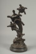 A BRONZE GROUP OF TWO TURTLES on a circular marble base.