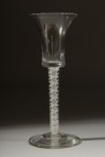 A GEORGIAN WINE GLASS with inverted bell shape bowl and white twist stem. 6ins high.
