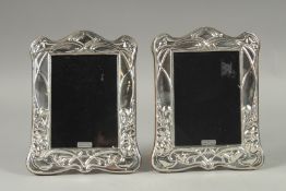 A PAIR OF SILVER PHOTOGRAPH FRAMES. 7.5ins x 5ins.