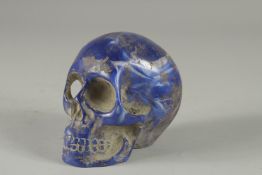 A CARVED LAPIS SKULL 3.5ins high.