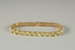 A SILVER GILT PERIDOT LINE BRACELET.