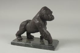 A BRONZE GORILLA on a metal base. 6ins high.