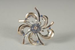 AN 18CT WHITE GOLD, DIAMOND AND SAPPHIRE CENTRAL BROOCH.