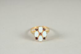 A SILVER, GOLD PLATED OPAL AND GARNET RING.
