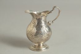 A GEORGE III SILVER CREAM JUG with scrolled decoration. London 1742. Maker: Elizabeth Godfrey.