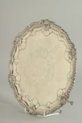 A VERY GOOD PIE CRUST CIRCULAR SALVER with gadrooned edge and shell mount, supported on three