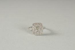 A PLATINUM DECO STYLE DIAMOND CLUSTER RING.