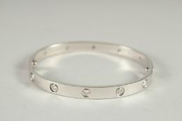 A GOOD CARTIER .750 GOLD AND DIAMOND BRACELET set with twelve diamonds.
