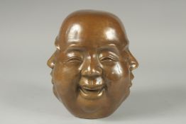 A LARGE BRONZE MULTI HEADED BUDDHA. 8ins.