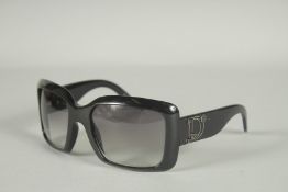 A PAIR OF BLACK DIOR SUN GLASSES in a case.