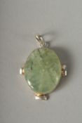 A SILVER OVAL JADE PENDANT.