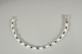 A SILVER OPAL AND SAPPHIRE LINE BRACELET.