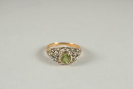 A 9CT GOLD PERIDOT AND PEARL RING.