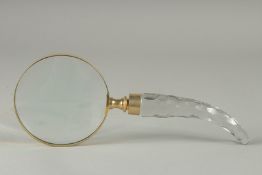 A MAGNIFYING GLASS with curving cut glass handle.