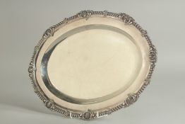 A GEORGE IV SILVER OVAL MEAT DISH by JOHN BRIDE with a gadrooned edge and shell border.. 15.5ins