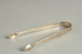 A PAIR OF ENGRAVED GEORGE III SILVER SUGAR TONGS by HESTER BATEMAN.