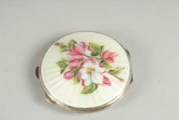 A SILVER AND ENAMEL CIRCULAR COMPACT.