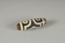 A GOLD INLAID DZI BEAD.