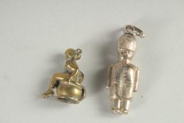 A SMALL SILVER GUARDSMAN KEY RING AND SMALL NUDE (2).