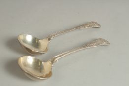 A PAIR OF VICTORIAN SILVER QUEENS PATTERN SAUCE LADLES. London 1850. Maker: J S. & A. S.