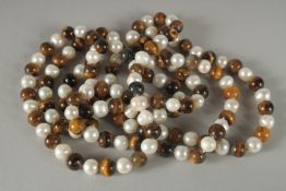 A STRING OF TWO COLOURED, JADE AND PEARLS. 48ins long