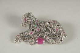 A SILVER RUBY, SAPPHIRE AND EMERALD PANTHER BROOCH.