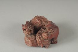 A CARVED WOOD BEAR AND DRAGON NETSUKE, Signed, 2ins.