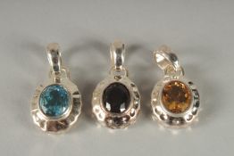THREE SILVER PENDANTS.