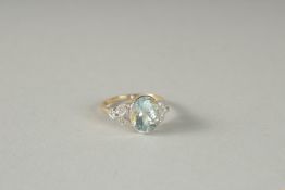 A GOOD 18CT GOLD OVAL AQUAMARINE AND DIAMOND RING.